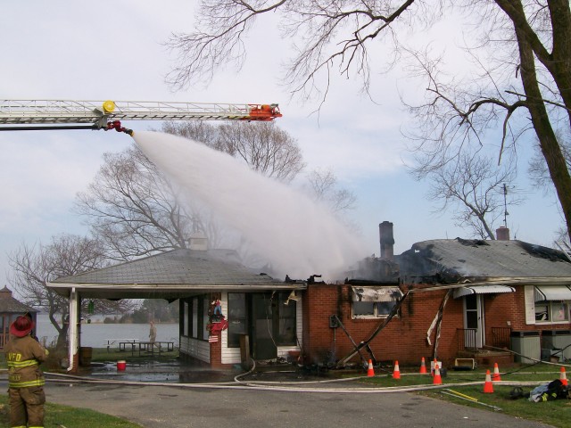The ladder pipe off of Truck 1 was utilized to mop up hot spots burning on the rafters and along the roof line